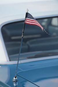 Low angle view of flag against blue sky