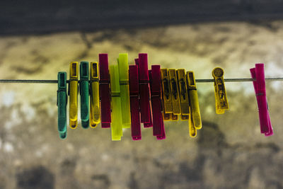 Close-up of clothespins hanging on clothesline