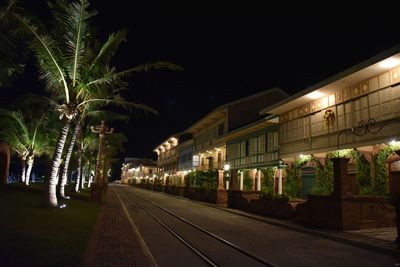 Illuminated railroad tracks at night