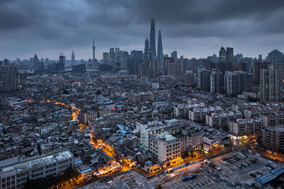 High angle view of illuminated cityscape against sky at dusk