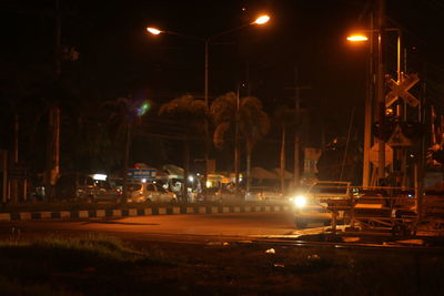 Illuminated street lights on road at night