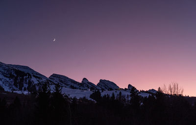 Scenic view of silhouette mountains against sky at night