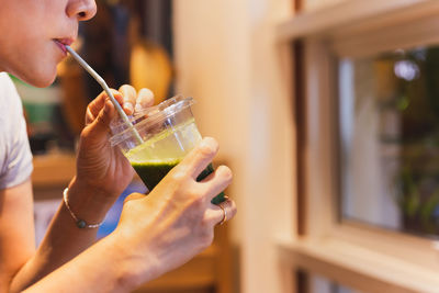 Close-up of woman drinking glass