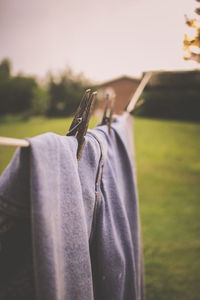 Close-up of clothes drying on clothesline against sky