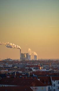 Smoke emitting from chimney against sky