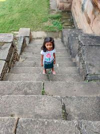 Portrait of smiling girl on staircase