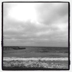 Scenic view of sea against cloudy sky