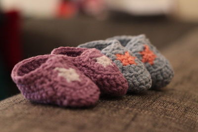 Close-up of baby booties on sofa 