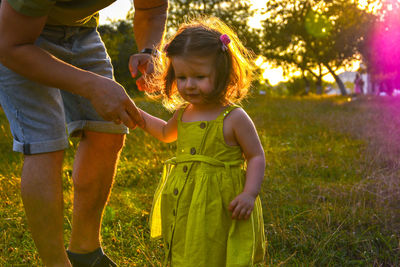 Cute little girl take hands with her father. walking with kids concept image. little girl holding 