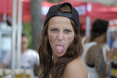 Portrait of beautiful woman sticking out tongue