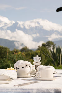 White tea on table against mountains