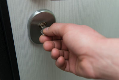 Cropped hand of person holding lock