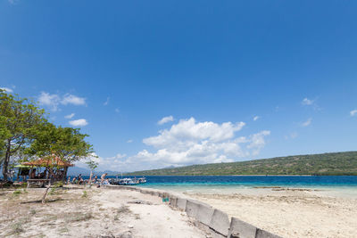 Scenic view of beach against blue sky