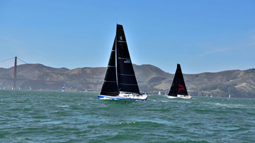 Sailboat sailing on sea against clear sky