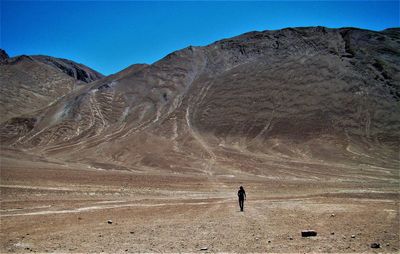 Full length of man on arid landscape against sky