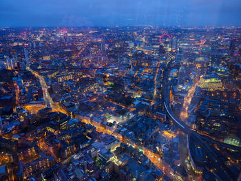 High angle view of city lit up at night