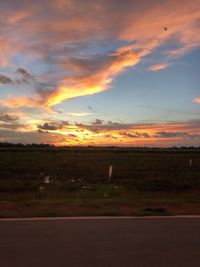 Scenic view of field against sky during sunset