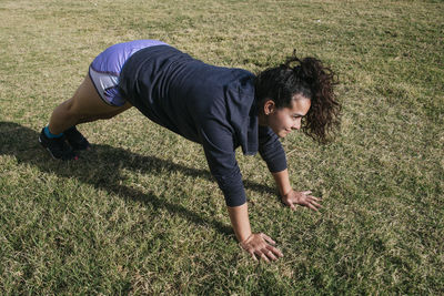 Young girl exercising in the grass