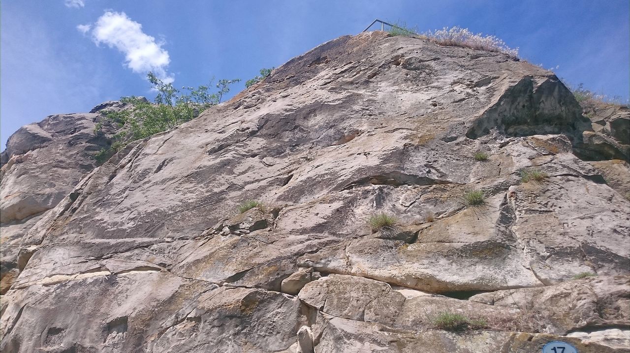 LOW ANGLE VIEW OF ROCK FORMATIONS ON MOUNTAIN AGAINST SKY