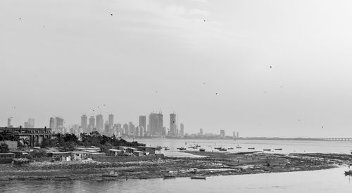 Scenic view of sea and buildings against sky