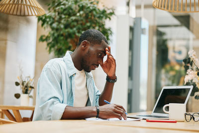 Male friends working at office