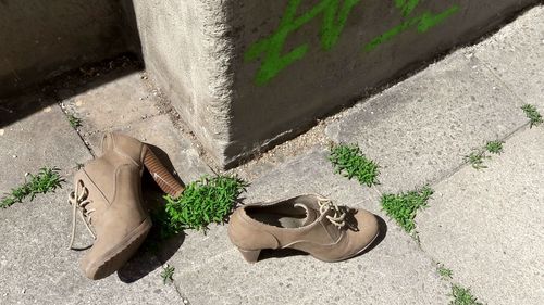 High angle view of shoes on sidewalk