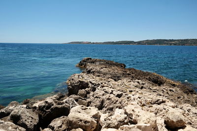 Scenic view of sea against clear blue sky