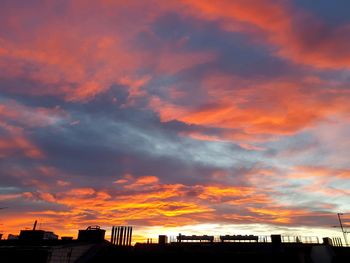 Scenic view of orange sky over city