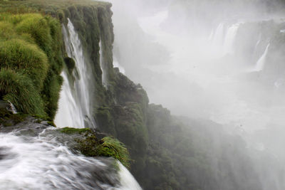 Scenic view of waterfall against sky