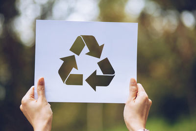 Midsection of person holding paper