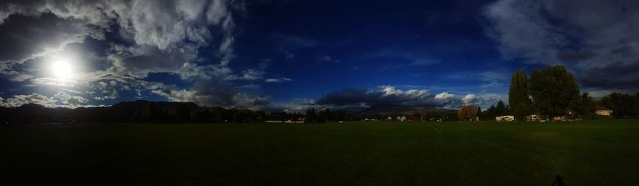 Panoramic view of illuminated park against sky at night