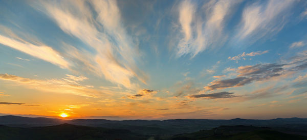 Scenic view of silhouette mountains against sky during sunset