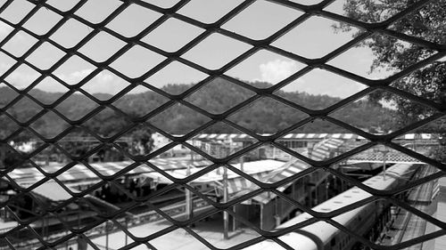 Close-up of chainlink fence against sky