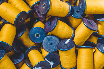 Full frame shot of yellow thread spools