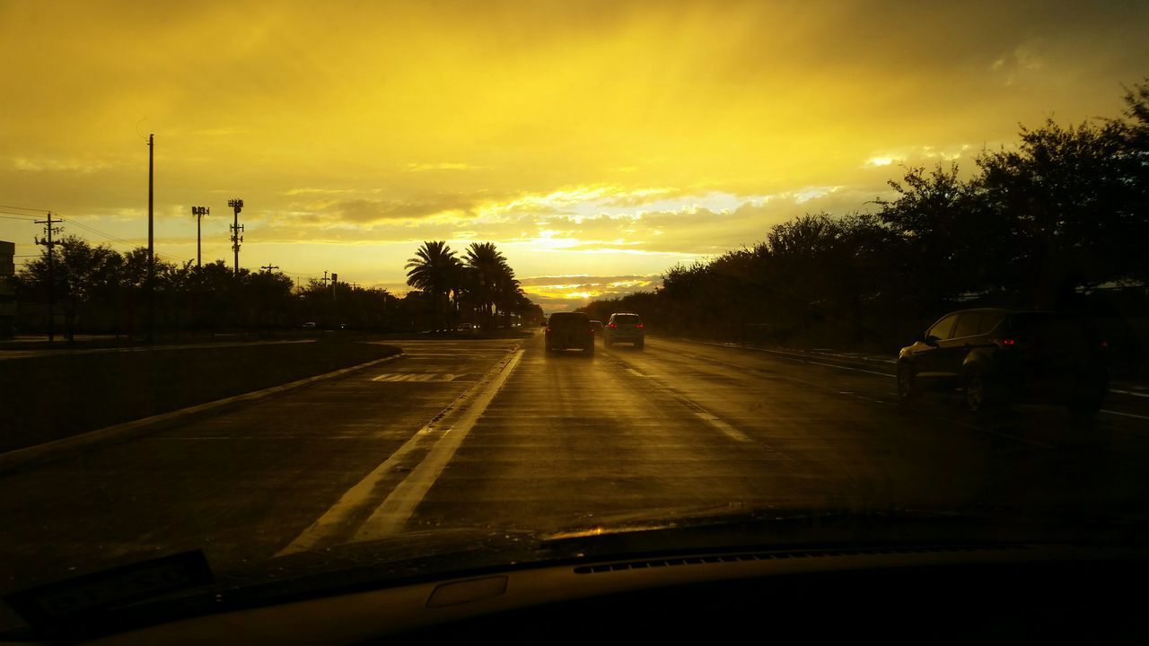 sunset, transportation, sky, cloud - sky, tree, silhouette, the way forward, mode of transport, orange color, land vehicle, road, railroad track, car, diminishing perspective, street light, cloud, cloudy, travel