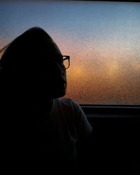 Rear view of man looking at window