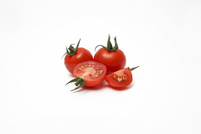 Close-up of tomatoes over white background