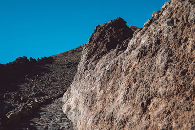 Low angle view of rock formation against clear sky