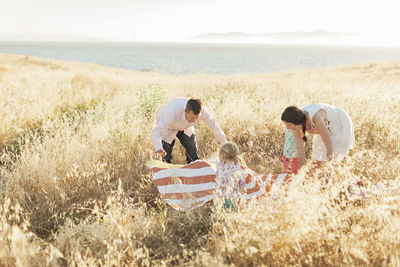 Family preparing picnic in meadow