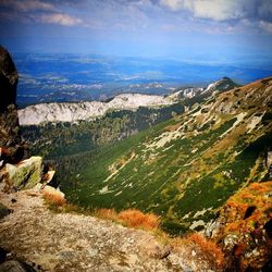 Scenic view of mountains against cloudy sky