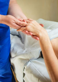 Massage therapist doing hand massage, close-up
