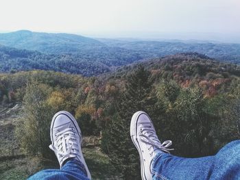 Low section of man standing on mountain