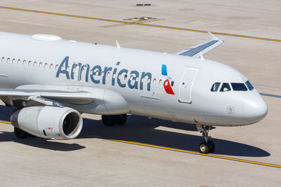 High angle view of airplane on airport runway