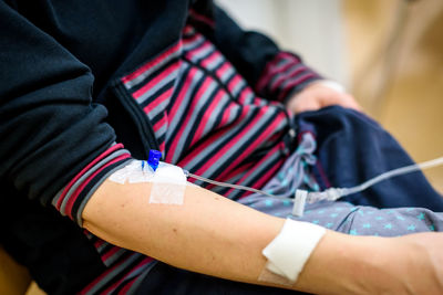 Midsection of patient with iv drip