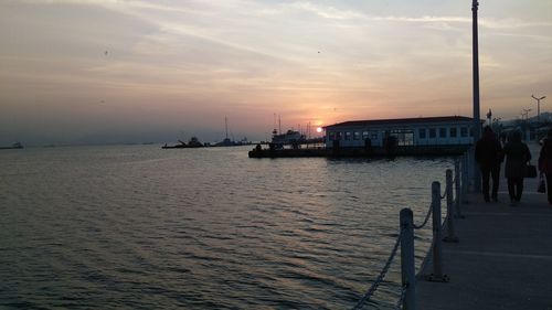 Pier on sea at sunset