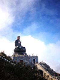 Low angle view of statue against cloudy sky