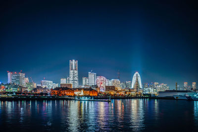 Illuminated city at waterfront