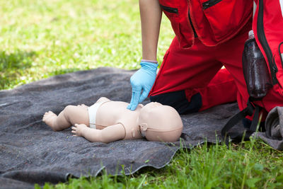 Volunteer giving first aid training with mannequin