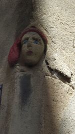 High angle view of stuffed toy on sand against wall