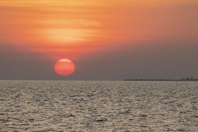 Scenic view of sea against orange sky